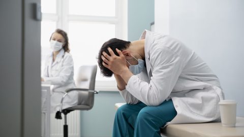 medium-shot-sad-doctor-wearing-mask